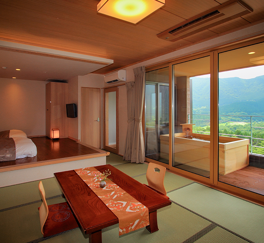 A suite with an outdoor hot spring bath with a spectacular view
